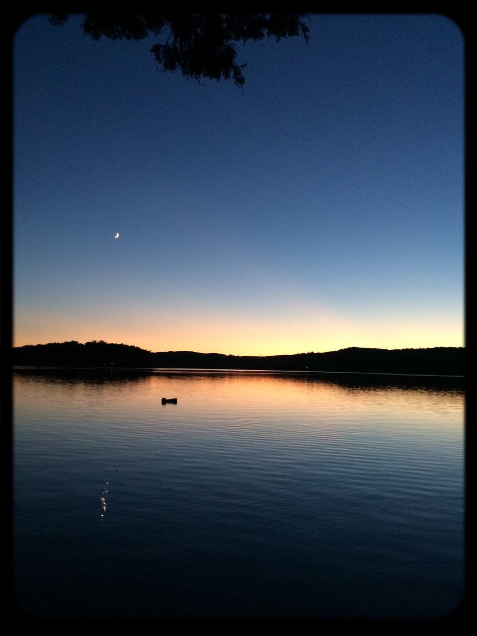 transfer print, water, tranquil scene, clear sky, auto post production filter, tranquility, scenics, copy space, lake, beauty in nature, silhouette, nature, reflection, blue, waterfront, sunset, tree, idyllic, calm, sky