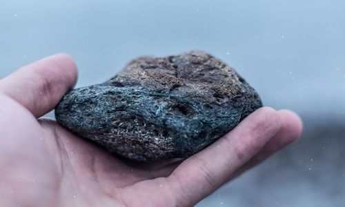 Close-up of stone on human palm