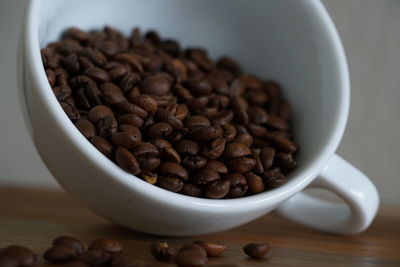 Close-up of coffee beans in bowl on table