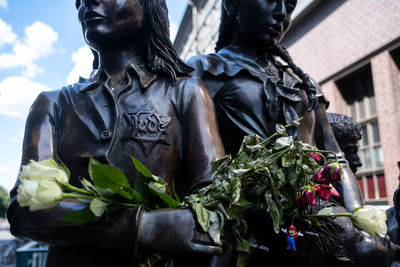 Statue of people holding flower pot