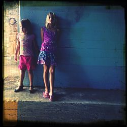 Full length of young woman standing by railing