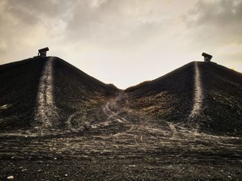 Low angle view of silhouette land against sky