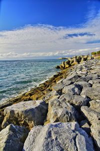 Rocks on beach against sky