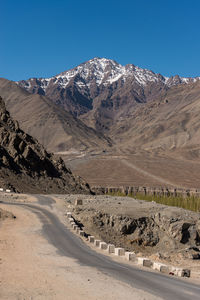 Scenic view of snowcapped mountains against clear sky