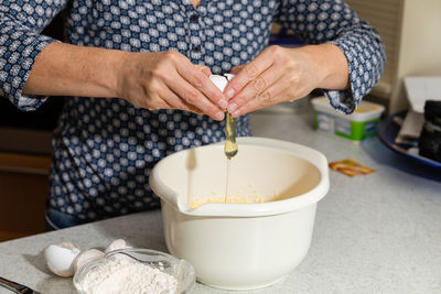 Midsection of woman preparing food in kitchen