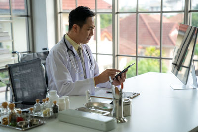 Portrait of doctor working at table