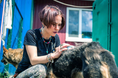 Dog at the shelter. animal shelter volunteer takes care of dogs. lonely dogs in cage with woman