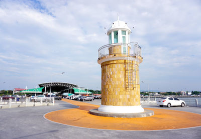 Lighthouse by sea against sky