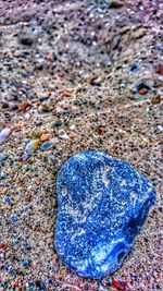 High angle view of pebbles on sand at beach