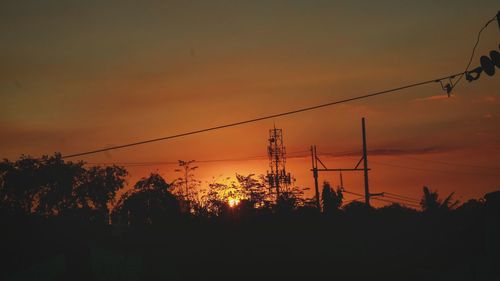 Low angle view of silhouette trees against sky during sunset