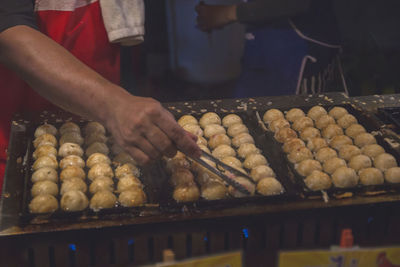 Midsection of man preparing food