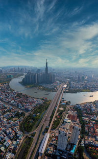 High angle view of city buildings against cloudy sky