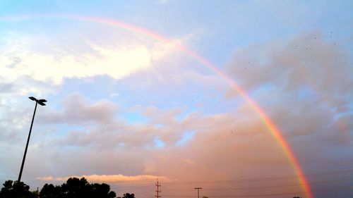 Low angle view of rainbow against sky at sunset