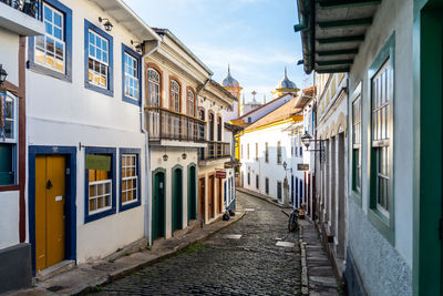 Empty street amidst buildings in city