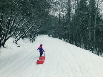 Girl on snow covered field