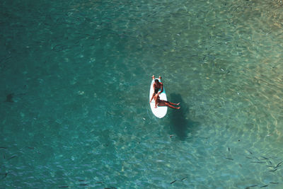 High angle view of couple swimming in sea