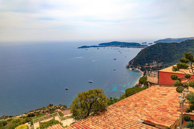 High angle view of townscape by sea against sky