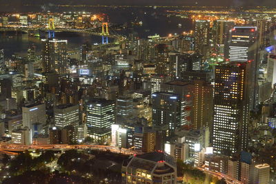 High angle view of illuminated buildings in city at night