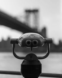 Close-up of coin-operated binoculars against sky