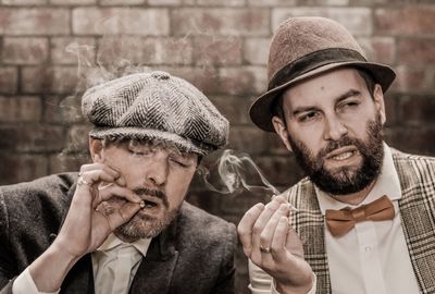 Close-up of friends smoking cigarettes