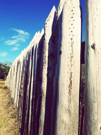 Low angle view of wooden post against sky