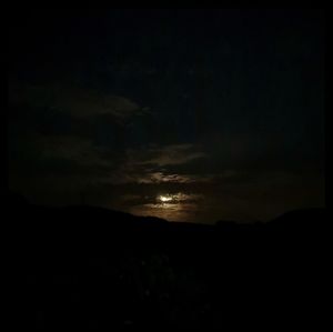 Scenic view of silhouette landscape against sky at night