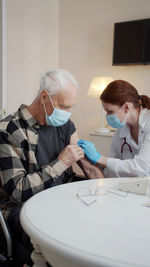 Doctor vaccinating patient in clinic