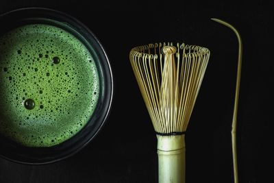 Directly above shot of drink on table against black background