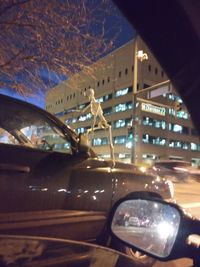 Reflection of illuminated car in city