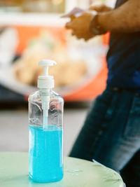 Close-up of person holding bottle