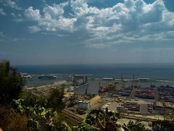High angle view of buildings by sea against sky