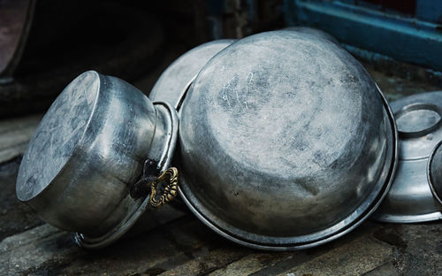 Close-up of metal pots on table