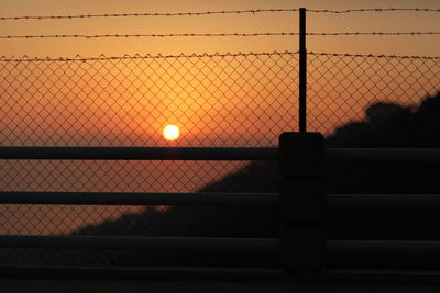 Chainlink fence at sunset