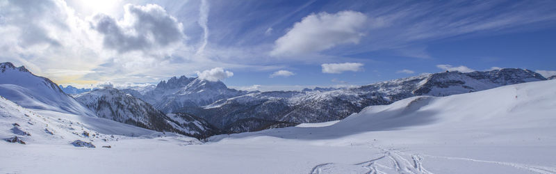 Snow covered landscape against the sky