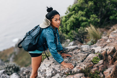 Woman looking away while rock climbing