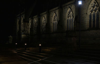Illuminated staircase by building at night