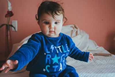 Portrait of cute boy sitting at home