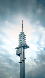 Low angle view of communications tower against sky