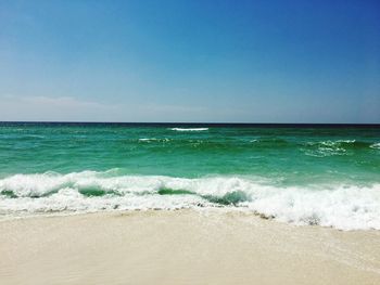 Scenic view of sea against clear blue sky