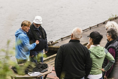 Rear view of people standing in water