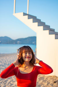 Portrait of a smiling young woman standing outdoors