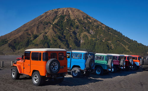 Tractor on road against clear blue sky
