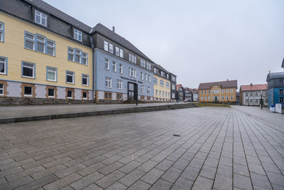 Footpath by building against sky