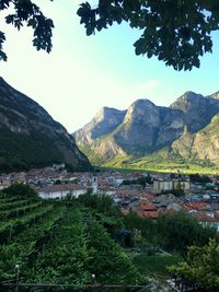 Scenic view of townscape by mountains against sky