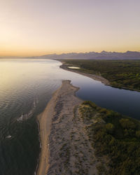 Scenic view of beach against sky during sunset