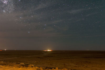 Scenic view of field against sky at night