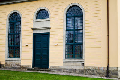 Closed door and arch windows of building