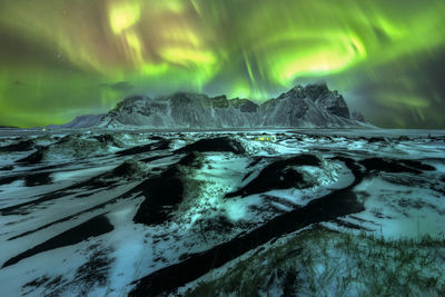 Scenic view of sea against sky at night during winter