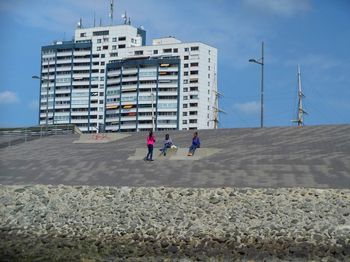 Rear view of people walking on beach