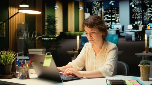Young woman using laptop on table